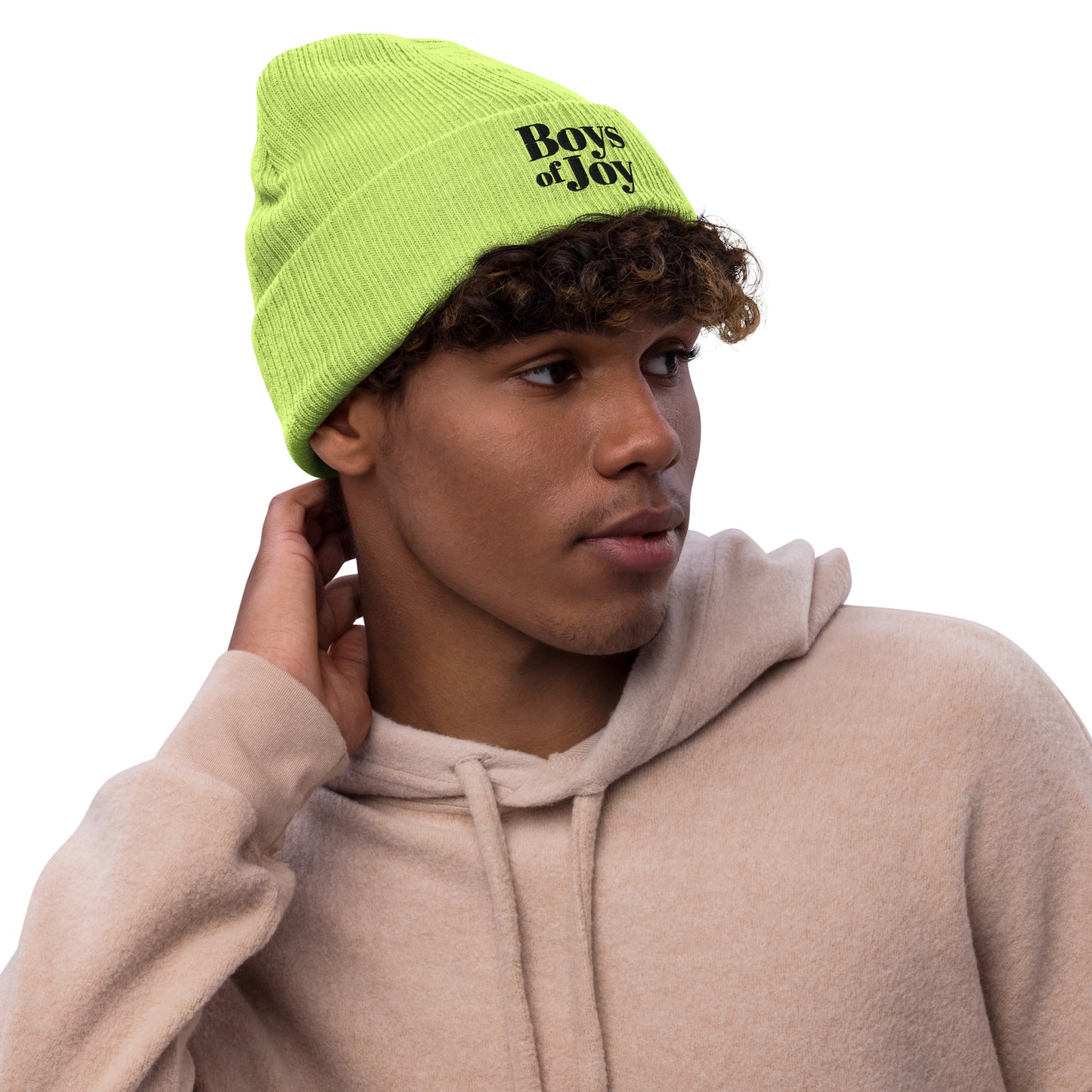 Model in beige hoodie wearing acid-green ribbed beanie with ‘Boys of Joy’ logo, three-quarter profile.
