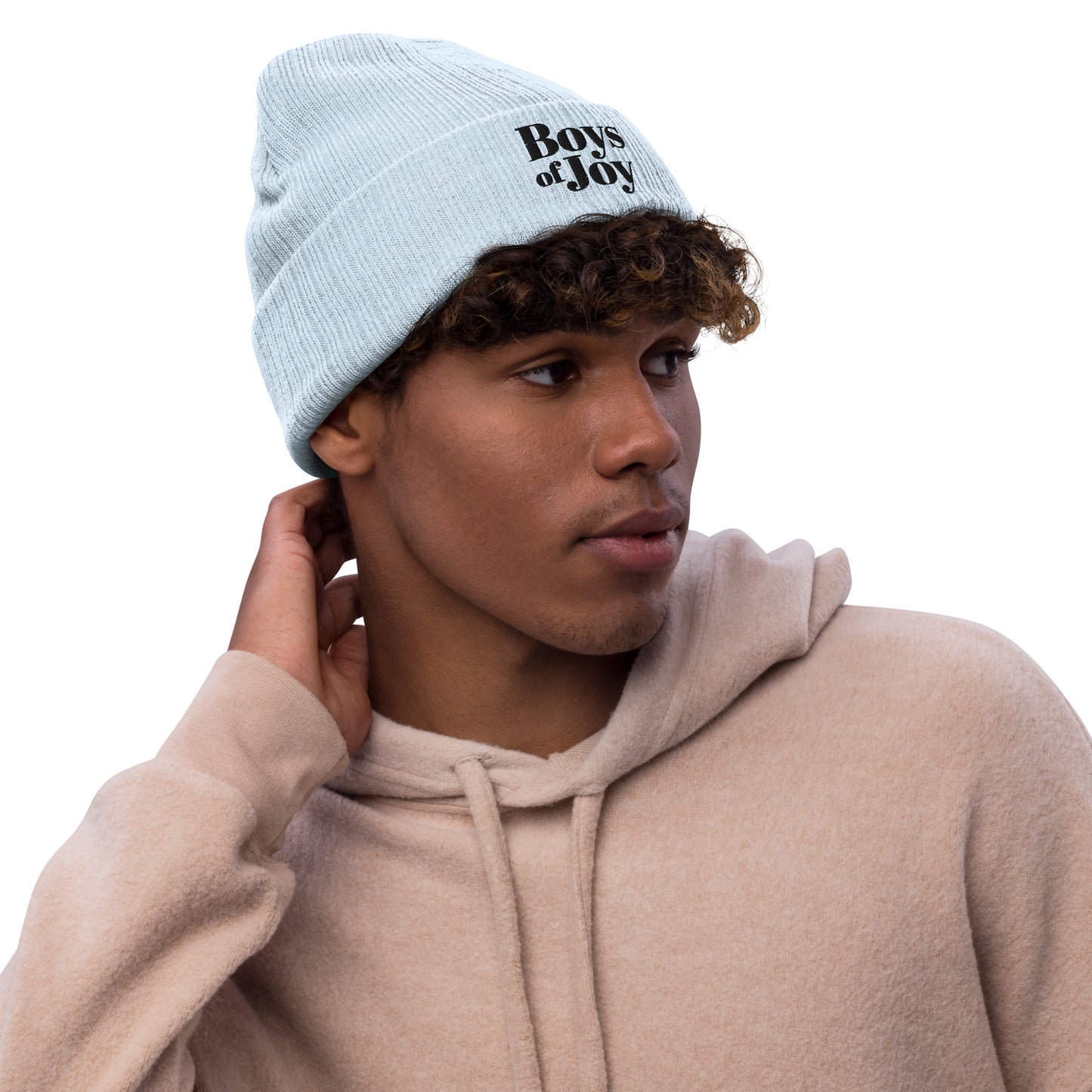 Model in a beige hoodie wearing a light-blue ribbed knit beanie with cuff and black ‘Boys of Joy’ embroidery, three-quarter view on white.