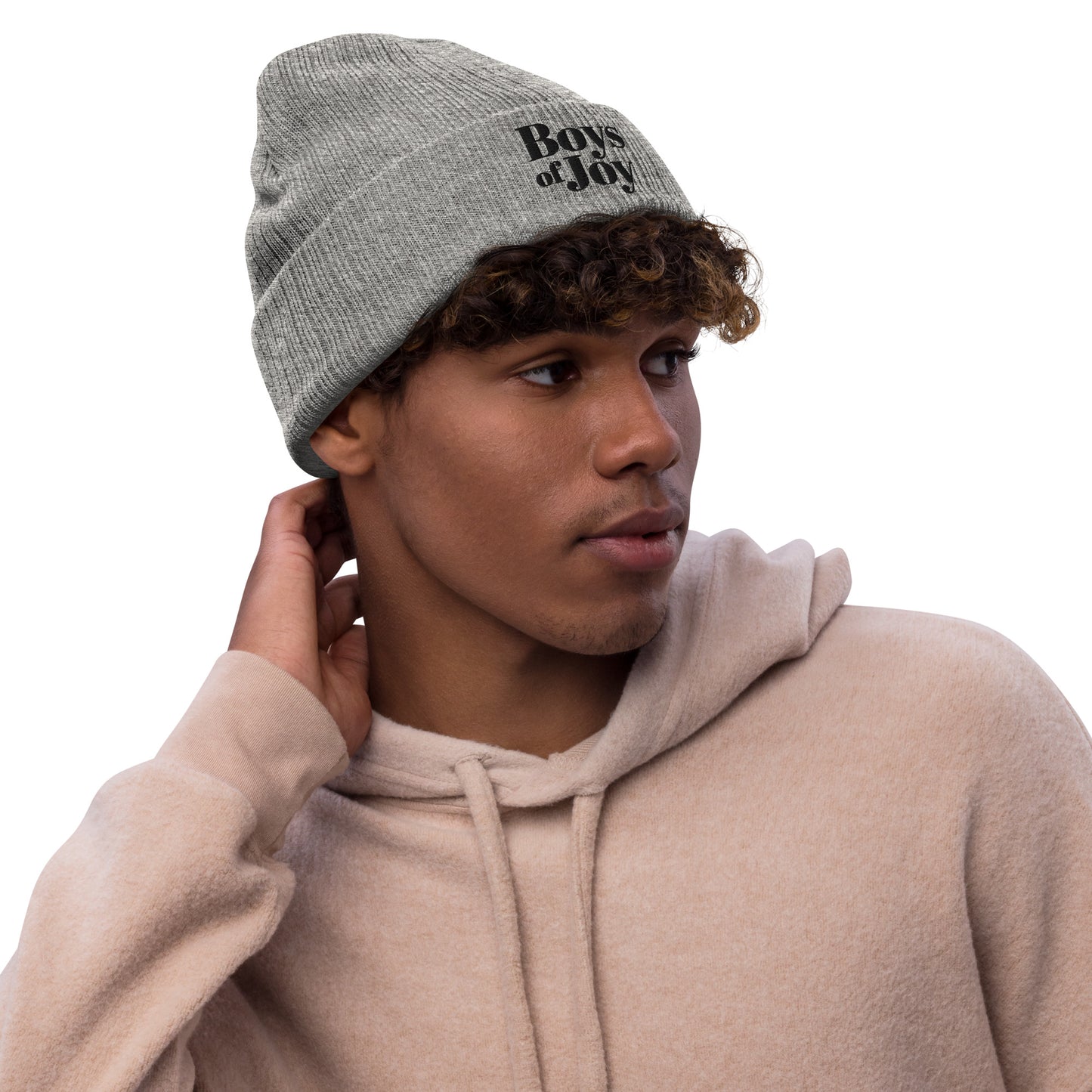 Model in beige hoodie wearing light-grey melange ribbed beanie with ‘Boys of Joy’ logo, three-quarter profile.